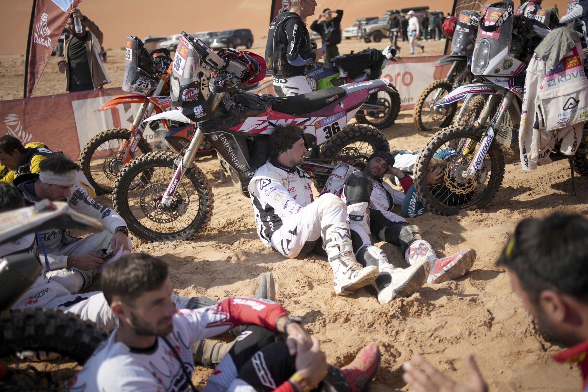 Riders wait at the start delayed due to fog during the eleventh stage of the Dakar Rally with start and finish in Shubaytah, Saudi Arabia, Thursday, Jan. 16, 2025. (AP Photo/Christophe Ena)