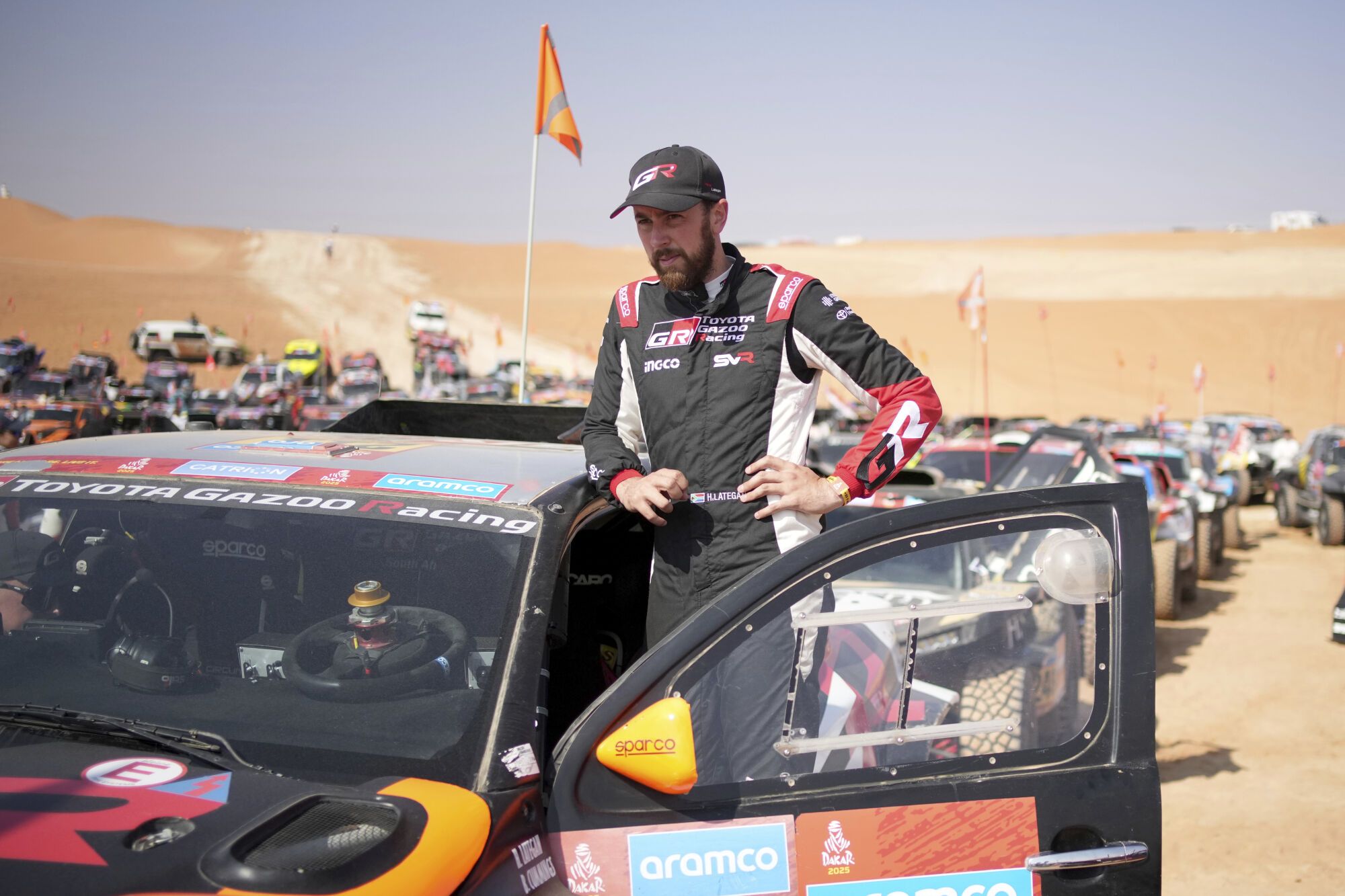 Driver Henk Lategan wait at the start delayed due to fog during the eleventh stage of the Dakar Rally with start and finish in Shubaytah, Saudi Arabia, Thursday, Jan. 16, 2025. (AP Photo/Christophe Ena)