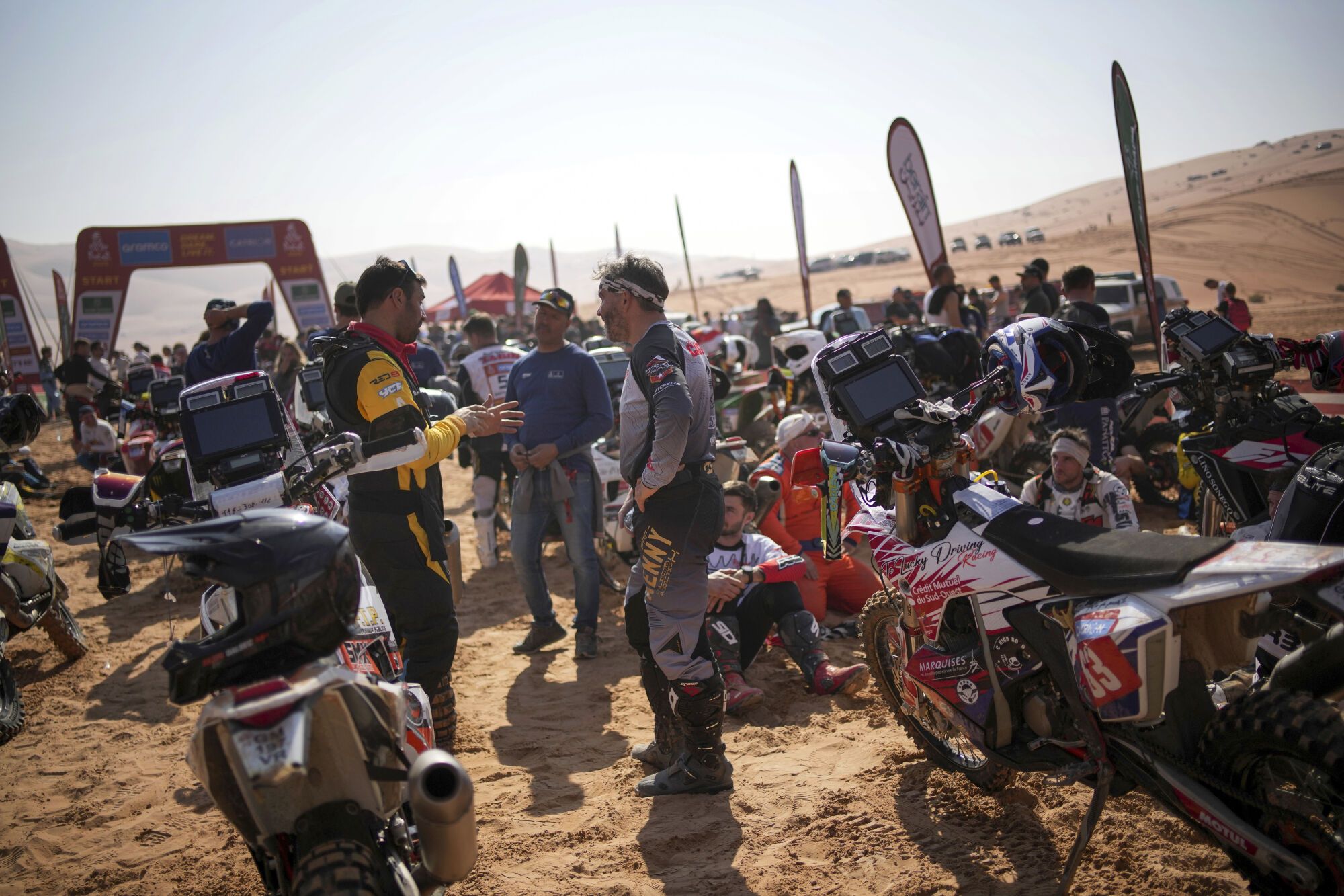 Riders wait at the start delayed due to fog during the eleventh stage of the Dakar Rally with start and finish in Shubaytah, Saudi Arabia, Thursday, Jan. 16, 2025. (AP Photo/Christophe Ena)