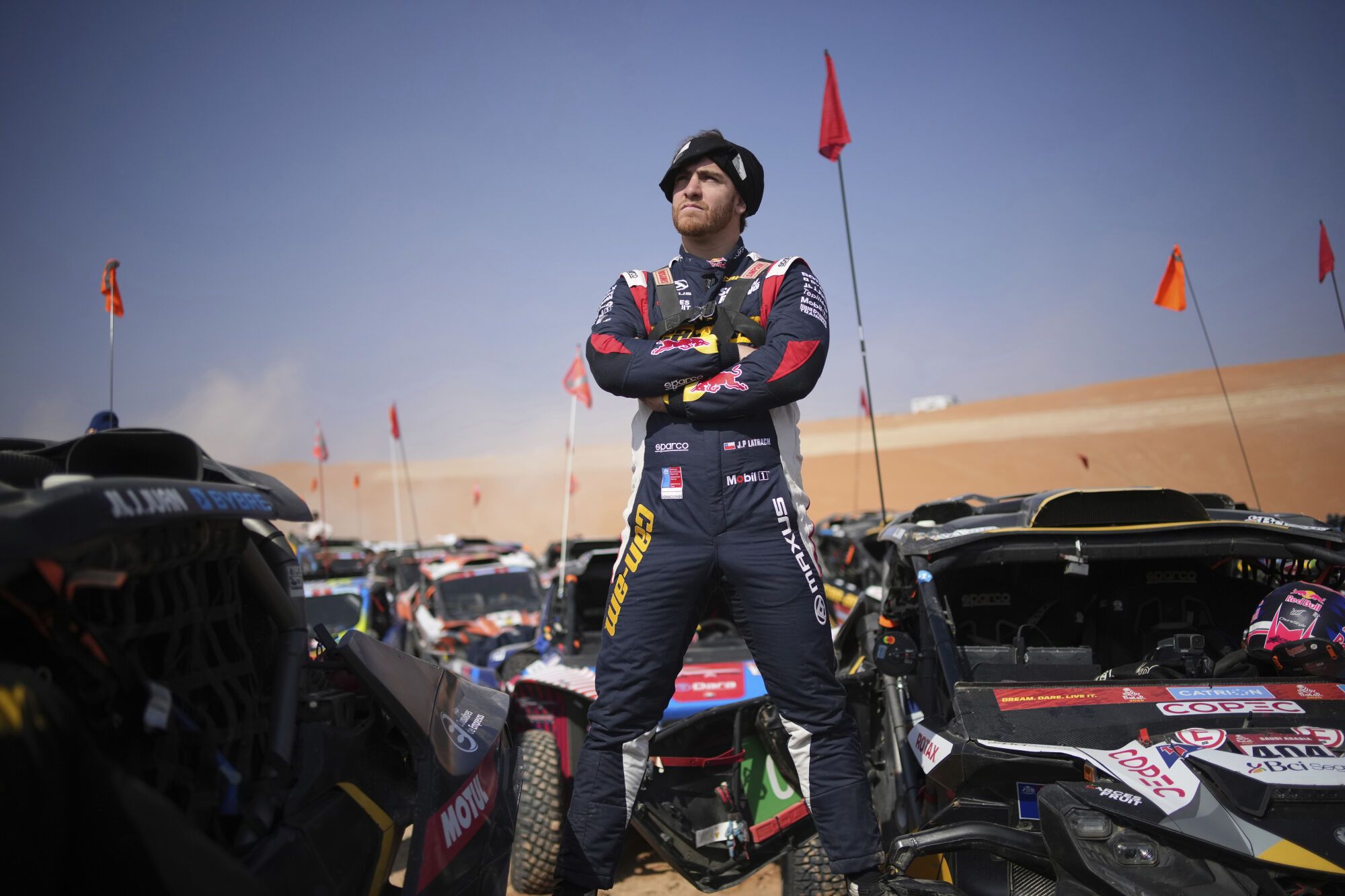 Co-driver Juan Pablo Latrach waits at the start delayed due to fog during the eleventh stage of the Dakar Rally with start and finish in Shubaytah, Saudi Arabia, Thursday, Jan. 16, 2025. (AP Photo/Christophe Ena)