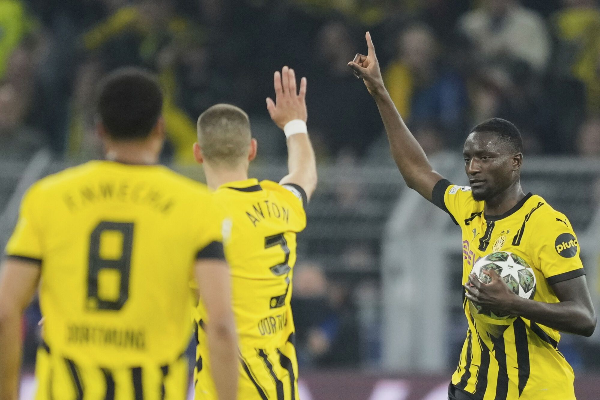 Dortmund's Serhou Guirassy, right, celebrates after scoring the opening goal during the Champions League quarterfinals second leg soccer match between Borussia Dortmund and Barcelona, at the Signa-Iduna Park in Dortmund, Germany, Tuesday, April 15, 2025. (AP Photo/Martin Meissner). EDITORIAL USE ONLY/ONLY ITALY AND SPAIN