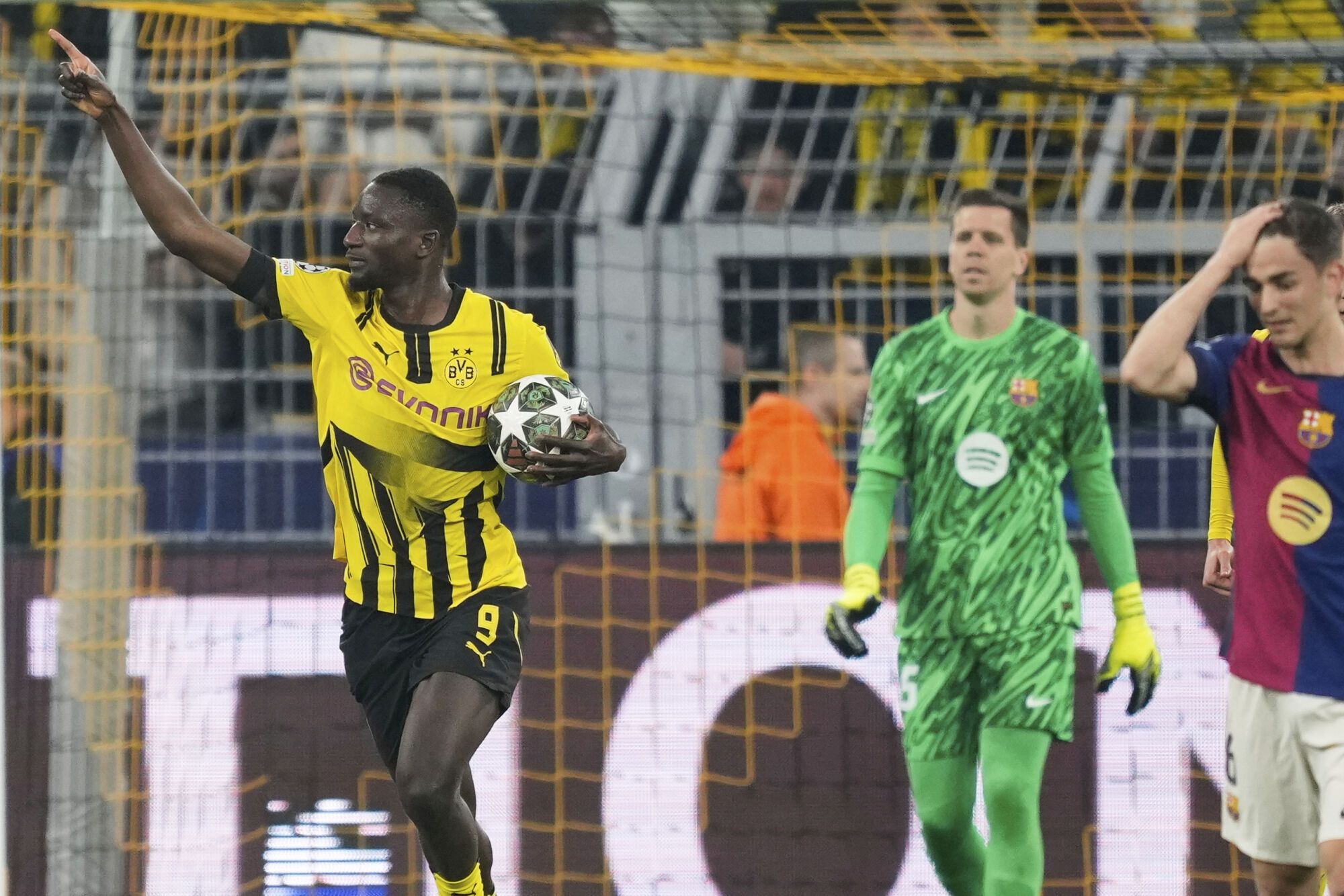 Dortmund's Serhou Guirassy, left, celebrates after scoring the opening goal during the Champions League quarterfinals second leg soccer match between Borussia Dortmund and Barcelona, at the Signa-Iduna Park in Dortmund, Germany, Tuesday, April 15, 2025. (AP Photo/Martin Meissner). EDITORIAL USE ONLY/ONLY ITALY AND SPAIN