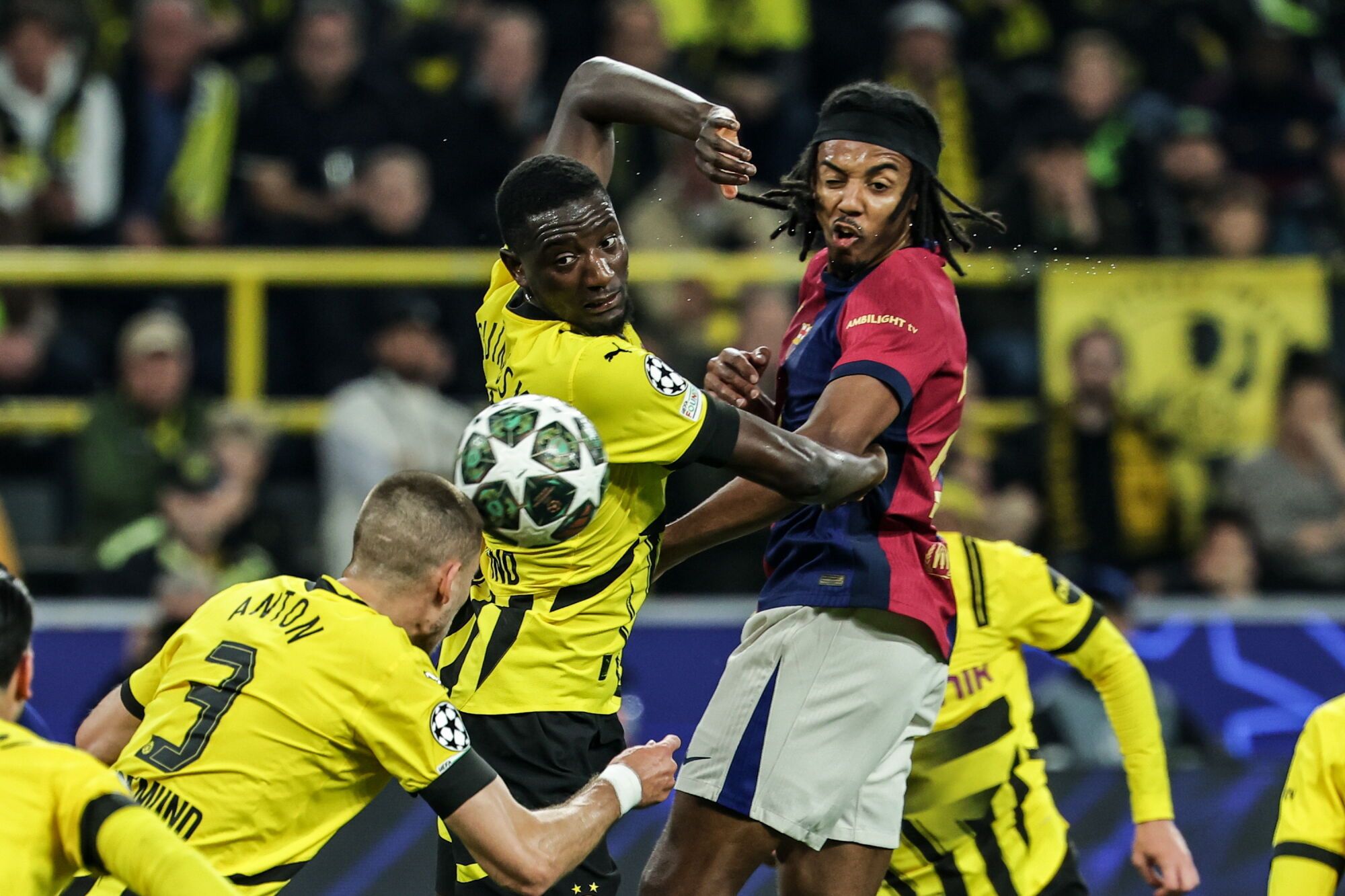 Dortmund (Germany), 15/04/2025.- Serhou Guirassy (C) and Waldemar Anton (L) of Dortmund in action against Jules Kounde of Barcelona during the UEFA Champions League quarter-finals, 2nd leg soccer match between Borussia Dortmund and FC Barcelona, in Dortmund, Germany, 15 April 2025. (Liga de Campeones, Alemania) EFE/EPA/FRIEDEMANN VOGEL